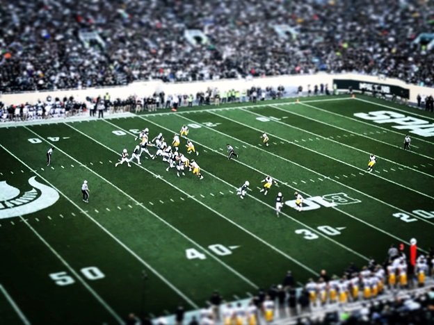An ongoing NFL match with the stadium full of crowd.
